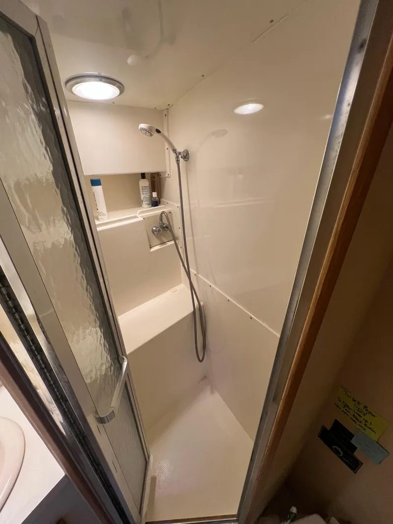 Slide: The Image of Shower area in 1989 Bertram 50 Convertible yacht, featuring a compact design. - 38