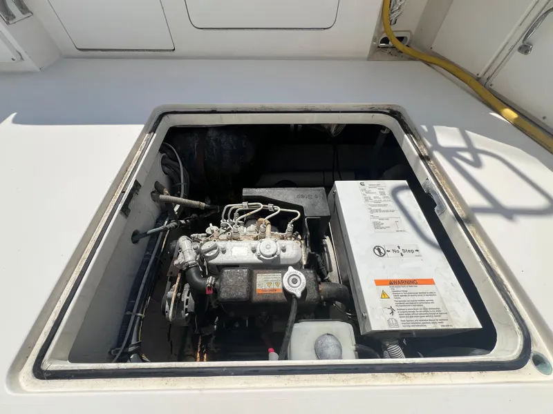 Slide: The Image of Engine compartment of a 1989 Bertram 50 Convertible boat, showcasing mechanical components. - 40
