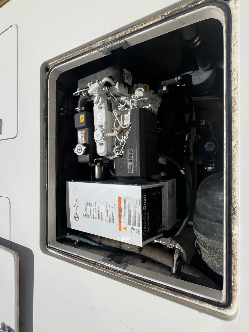 Slide: The Image of Engine compartment of a 1989 Bertram 50 Convertible boat, featuring a Cummins Onan generator. - 42