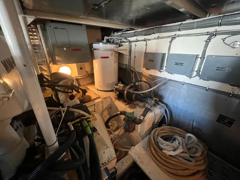 Slide: The Image of Engine room of 1989 Bertram 50 Convertible with equipment and coiled ropes. - 48