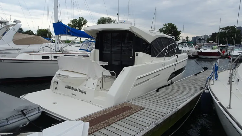 Slide: The Image of 2018 Carver C34 Coupe yacht docked at marina, surrounded by other boats. - 1