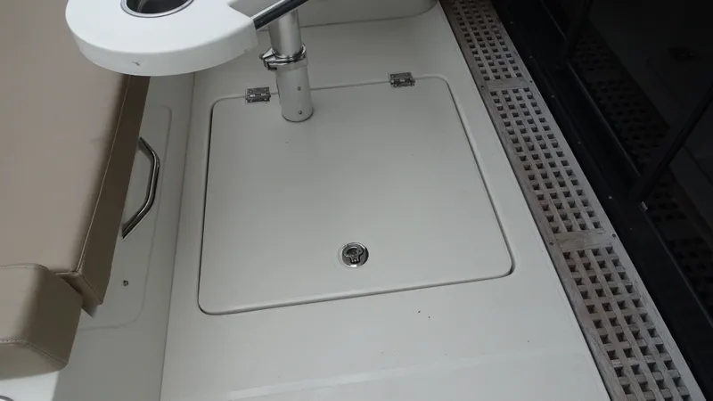 Slide: The Image of 2018 Carver C34 Coupe deck area with seating and storage compartment. - 13