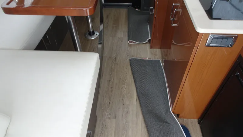 Slide: The Image of Interior of 2018 Carver C34 Coupe with wood flooring and modern furnishings. - 27