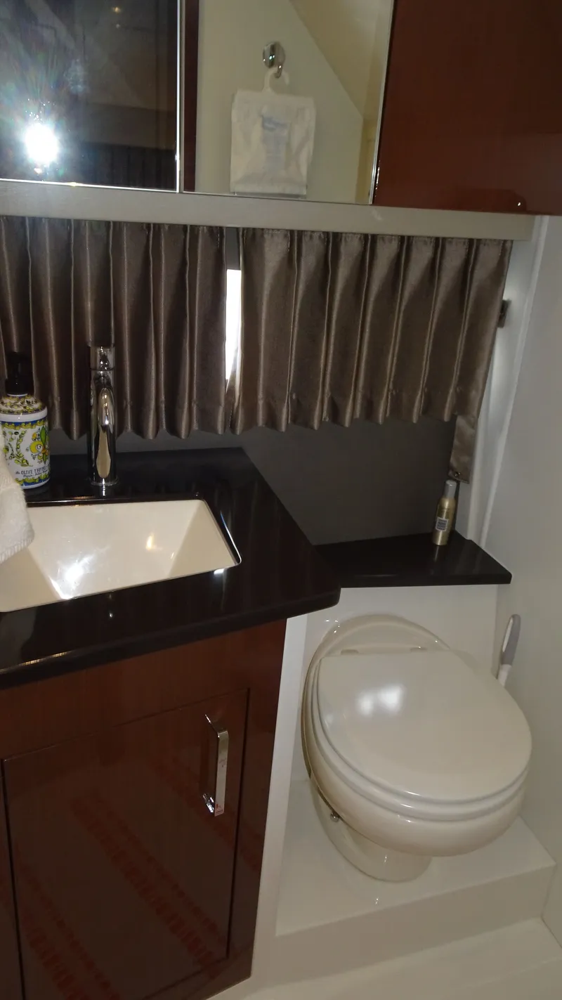 Slide: The Image of 2018 Carver C34 Coupe bathroom with sink, toilet, and curtain. - 39