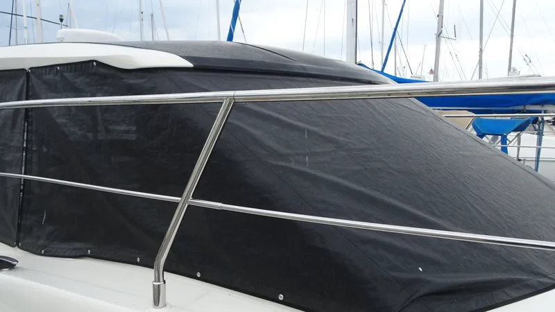 Slide: The Image of 2018 Carver C34 Coupe yacht with protective cover in marina. - 4