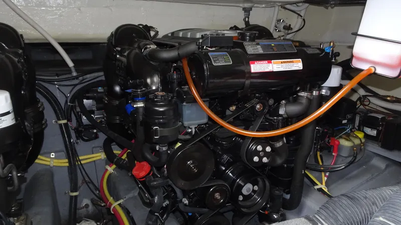 Slide: The Image of Engine compartment of 2018 Carver C34 Coupe, showcasing detailed mechanical components. - 47