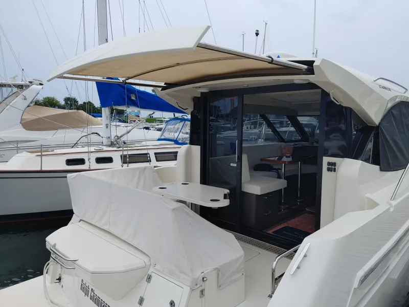 Slide: The Image of 2018 Carver C34 Coupe yacht with open deck, docked at marina. - 16