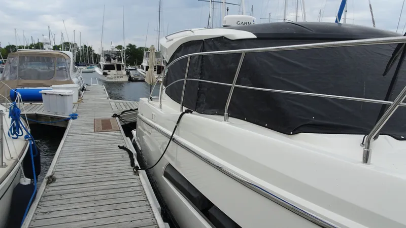 Slide: The Image of 2018 Carver C34 Coupe docked at marina with other boats. - 2
