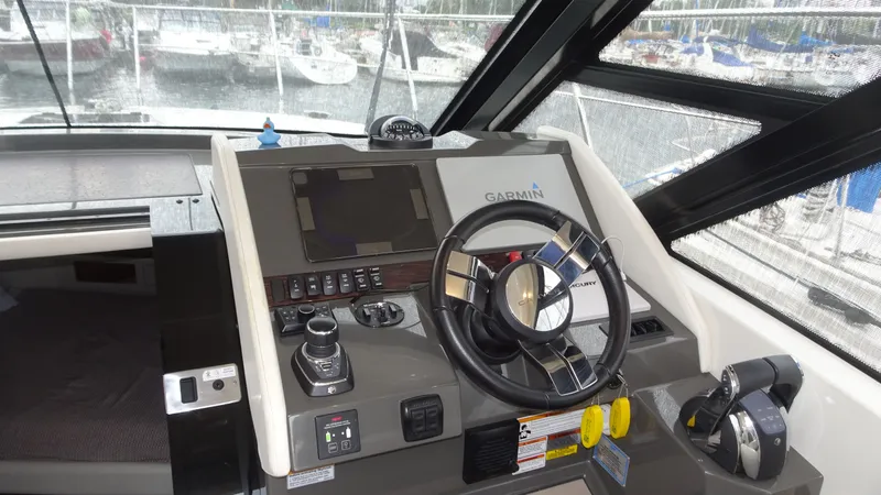 Slide: The Image of 2018 Carver C34 Coupe helm with Garmin navigation system and modern controls. - 22