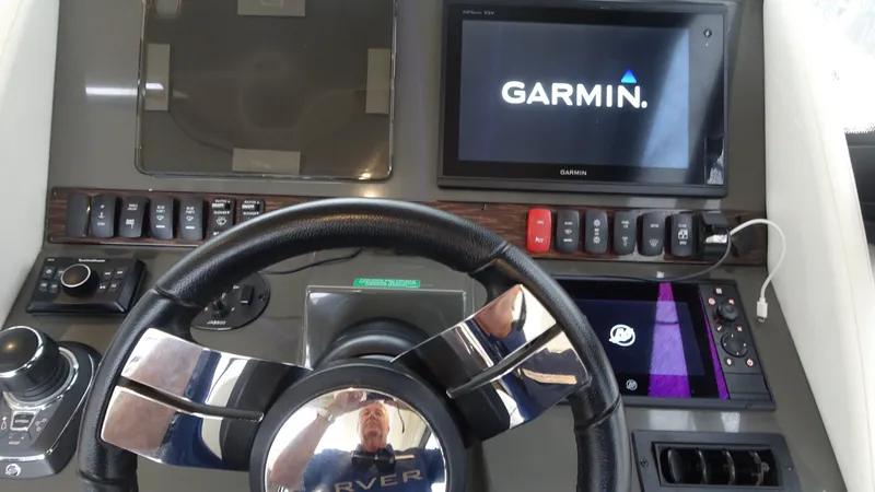 Slide: The Image of 2018 Carver C34 Coupe dashboard with Garmin navigation system and steering wheel. - 31