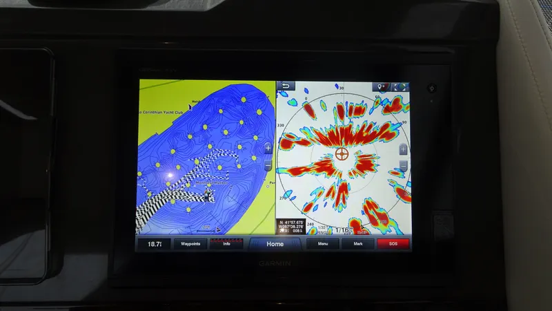 Slide: The Image of Garmin navigation display on 2018 Carver C34 Coupe, showing detailed marine charts and radar. - 32