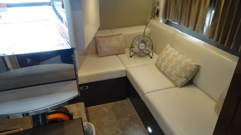 Slide: The Image of Luxurious interior of 2018 Carver C34 Coupe with white seating and decorative pillows. - 37