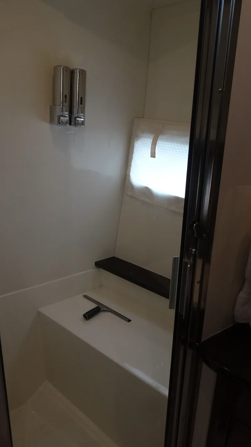 Slide: The Image of Shower area in 2018 Carver C34 Coupe with dispensers and window. - 40