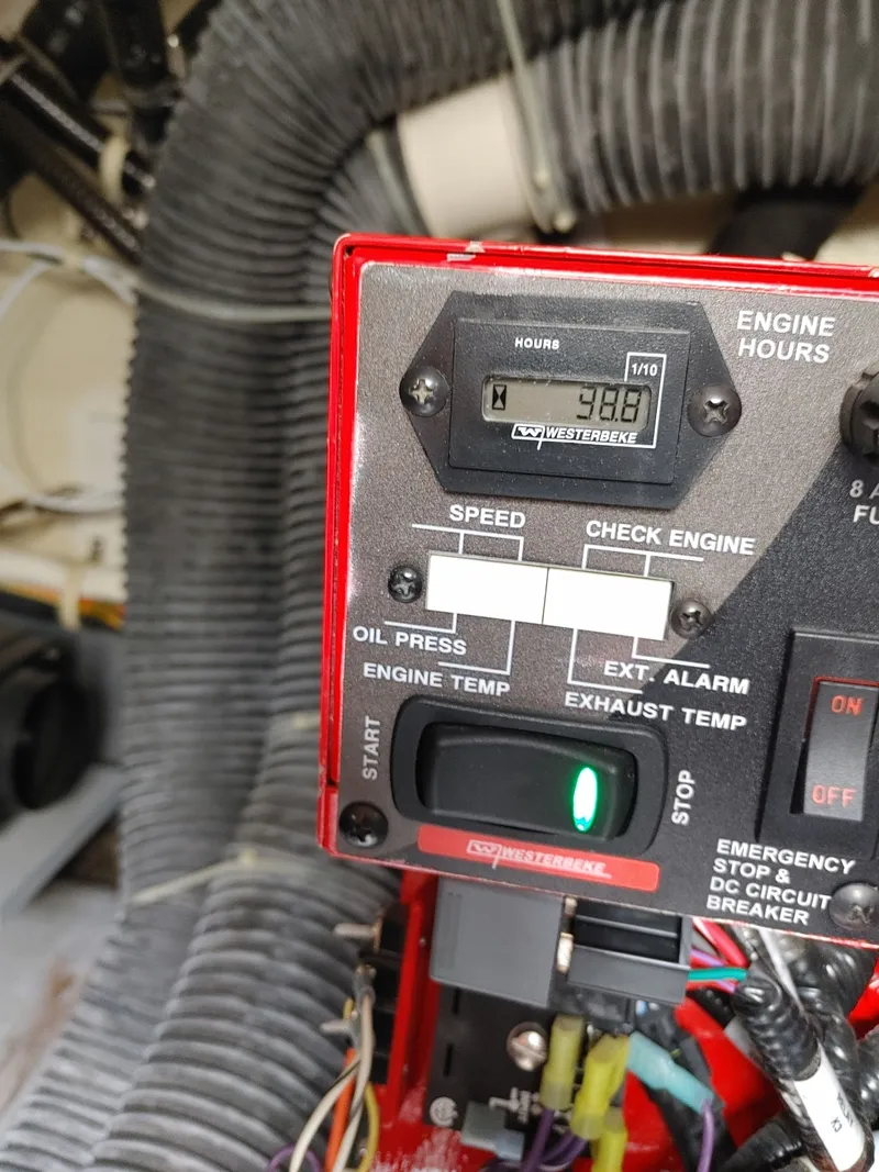 Slide: The Image of Engine control panel with hour meter, switches, and wiring in a 2018 Carver C34 Coupe. - 43