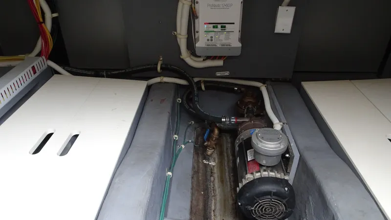 Slide: The Image of Engine compartment of 2018 Carver C34 Coupe with visible wiring and machinery components. - 44