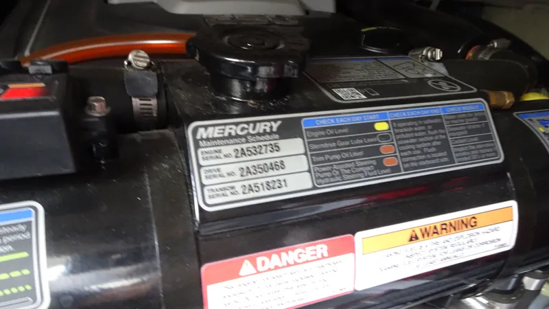 Slide: The Image of Mercury engine maintenance labels on a 2018 Carver C34 Coupe. - 49
