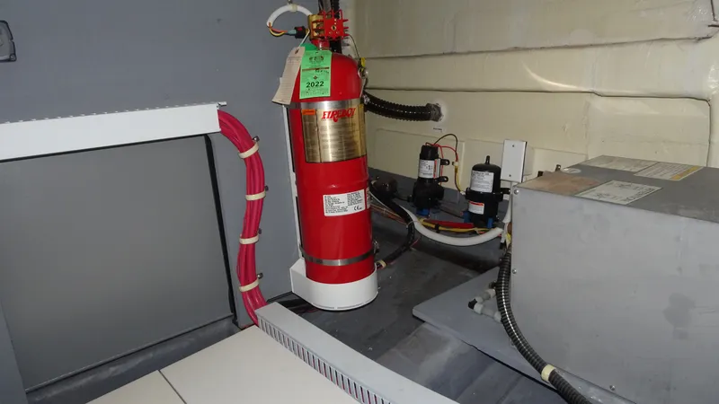 Slide: The Image of Engine room of 2018 Carver C34 Coupe with fire extinguisher and equipment. - 51