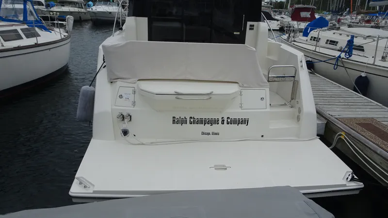 Slide: The Image of 2018 Carver C34 Coupe yacht docked at marina, rear view. - 6