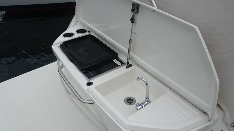 Slide: The Image of Outdoor sink and grill on 2018 Carver C34 Coupe yacht deck. - 9