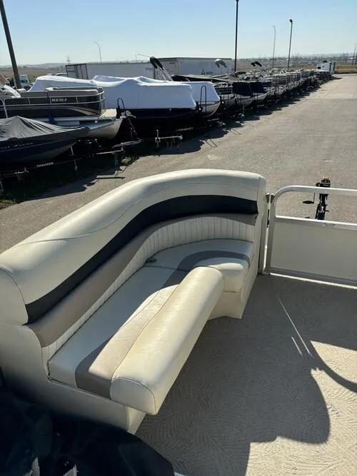 Slide: The Image of 2008 Bennington 2075GSi pontoon boat with beige seating, docked in a marina. - 11