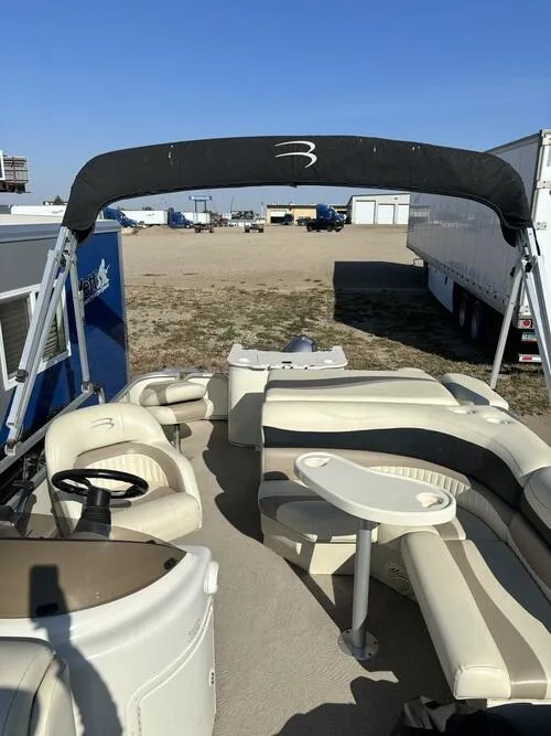 Slide: The Image of 2008 Bennington 2075GSi pontoon boat with beige seating and canopy in a storage area. - 4