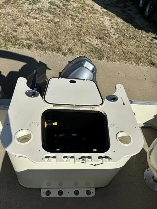 Slide: The Image of 2008 Bennington 2075GSi boat with open storage compartment and motor, on dry land. - 7