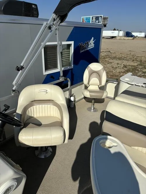 Slide: The Image of 2008 Bennington 2075GSi boat interior with beige seating and steering wheel. - 9