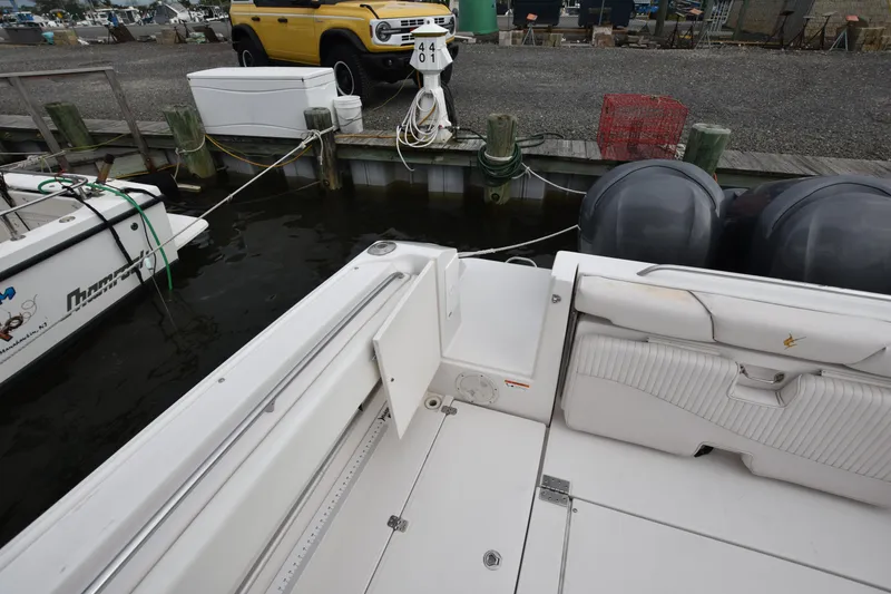 Slide: The Image of 2007 Seaswirl Striper 2901 Walkaround O/B docked, featuring spacious deck and dual outboard engines. - 11