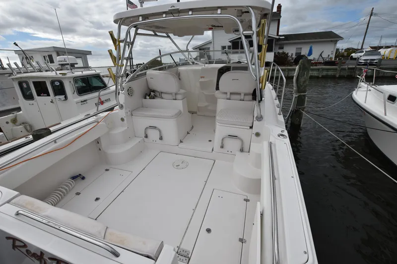 Slide: The Image of 2007 Seaswirl Striper 2901 Walkaround O/B boat docked, spacious deck, overcast sky. - 12