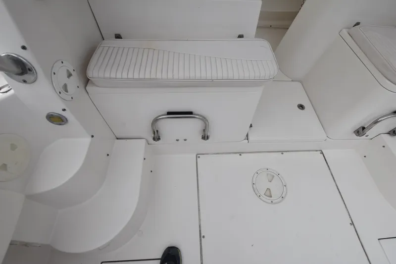 Slide: The Image of 2007 Seaswirl Striper 2901 Walkaround O/B boat interior with white seating and storage. - 16