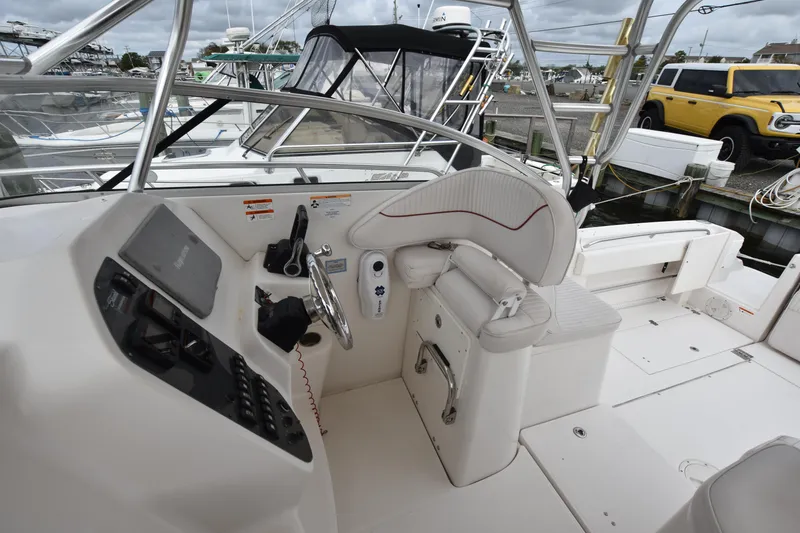 Slide: The Image of 2007 Seaswirl Striper 2901 Walkaround O/B boat cockpit with steering wheel and controls. - 18