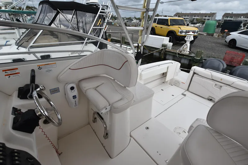 Slide: The Image of 2007 Seaswirl Striper 2901 Walkaround O/B boat interior with helm and seating area. - 19