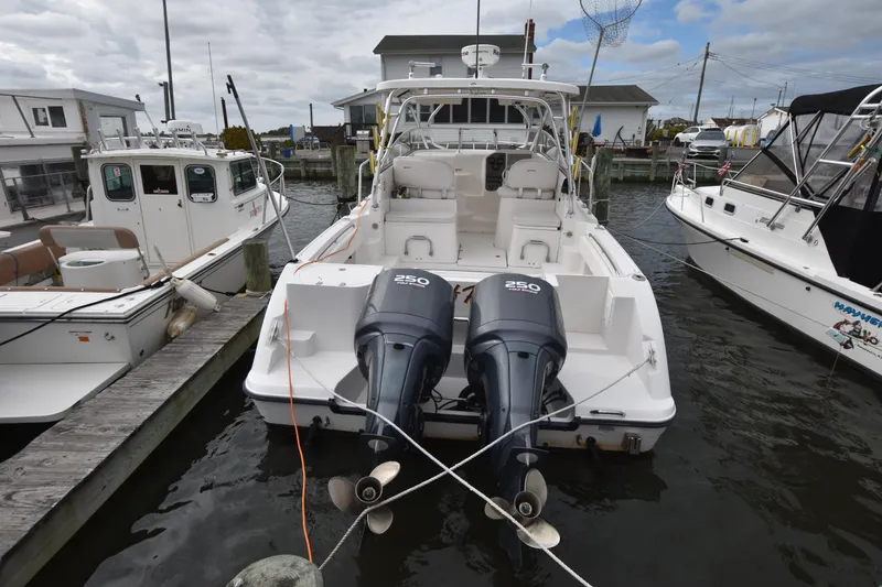 Slide: The Image of 2007 Seaswirl Striper 2901 Walkaround O/B docked with dual outboard engines. - 2