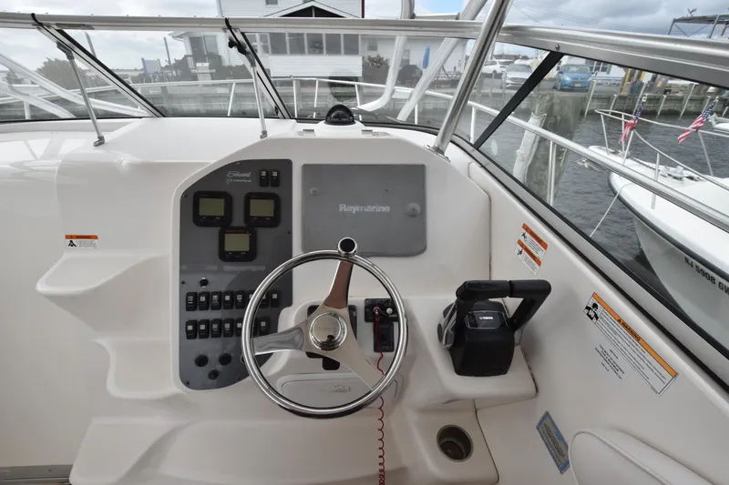 Slide: The Image of 2007 Seaswirl Striper 2901 Walkaround O/B helm with steering wheel and control panel. - 20