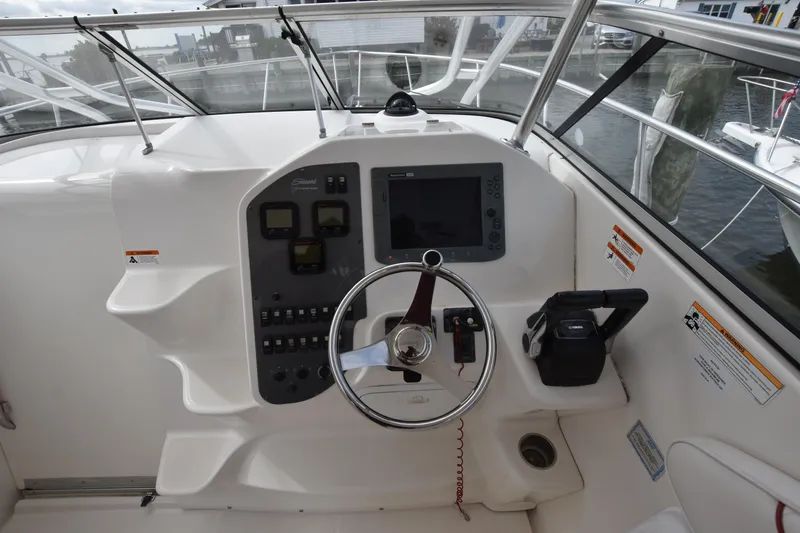 Slide: The Image of 2007 Seaswirl Striper 2901 Walkaround O/B helm with steering wheel and navigation controls. - 21