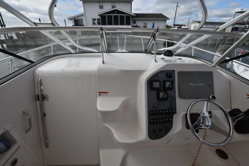 Slide: The Image of 2007 Seaswirl Striper 2901 Walkaround O/B boat cockpit with steering wheel and control panel. - 22