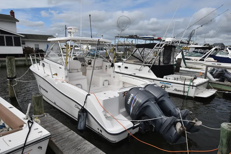 Slide: The Image of 2007 Seaswirl Striper 2901 Walkaround O/B docked with twin outboard engines. - 3