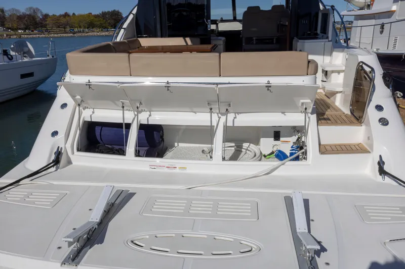Slide: The Image of 2016 Sea Ray 510 Sundancer yacht with open storage compartments at the stern. - 23