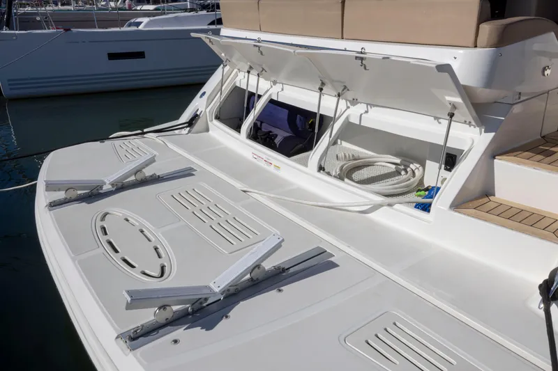 Slide: The Image of 2016 Sea Ray 510 Sundancer yacht with open storage compartments and deck view. - 24