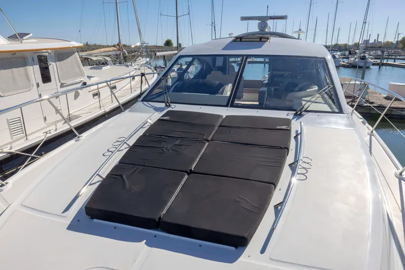 Slide: The Image of 2016 Sea Ray 510 Sundancer yacht with sun pads, docked in a marina. - 29