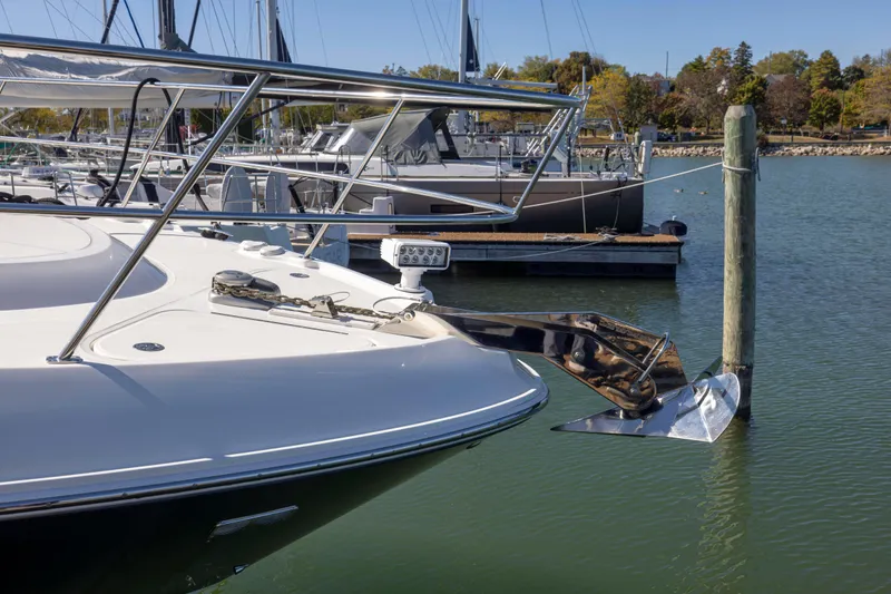 Slide: The Image of 2016 Sea Ray 510 Sundancer yacht docked in a marina, featuring sleek design and anchor. - 30