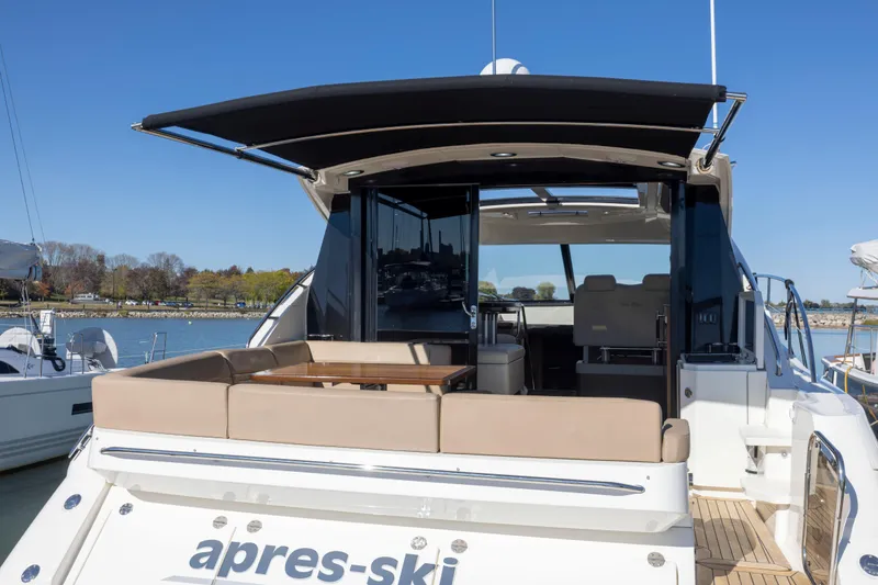 Slide: The Image of 2016 Sea Ray 510 Sundancer yacht with open canopy, docked at marina. - 35