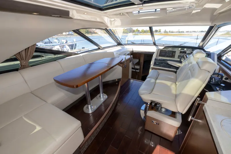 Slide: The Image of Luxurious interior of 2016 Sea Ray 510 Sundancer yacht with leather seating and wooden table. - 45