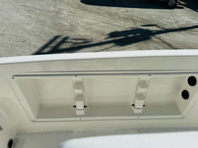Slide: The Image of 2025 Bayliner Trophy T18 boat interior detail, showing storage compartment and clean design. - 11