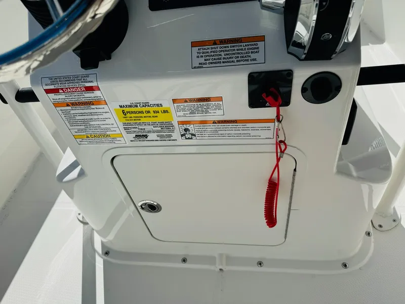 Slide: The Image of 2025 Bayliner Trophy T18 console with safety warnings and red safety lanyard. - 13