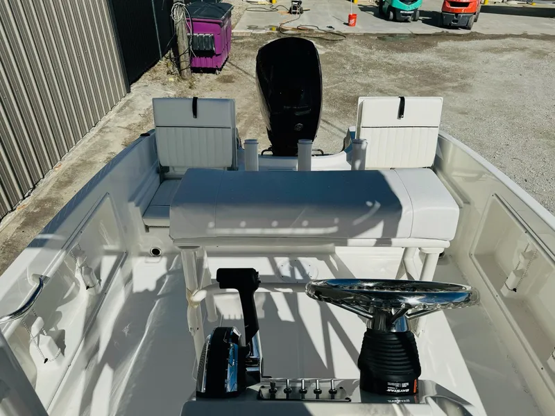 Slide: The Image of 2025 Bayliner Trophy T18 boat interior with steering wheel and seating. - 14