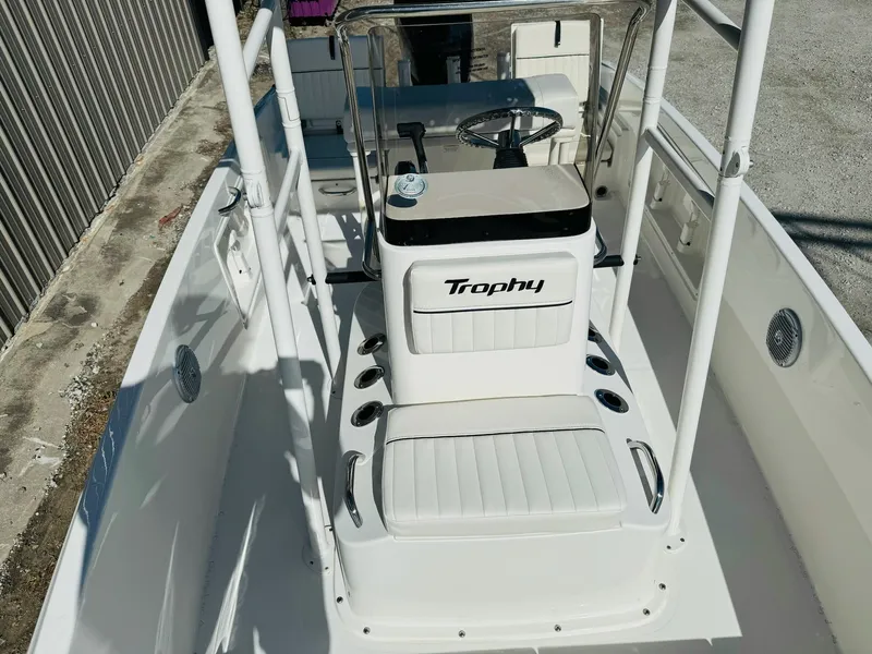Slide: The Image of 2025 Bayliner Trophy T18 boat interior with steering console and seating. - 15