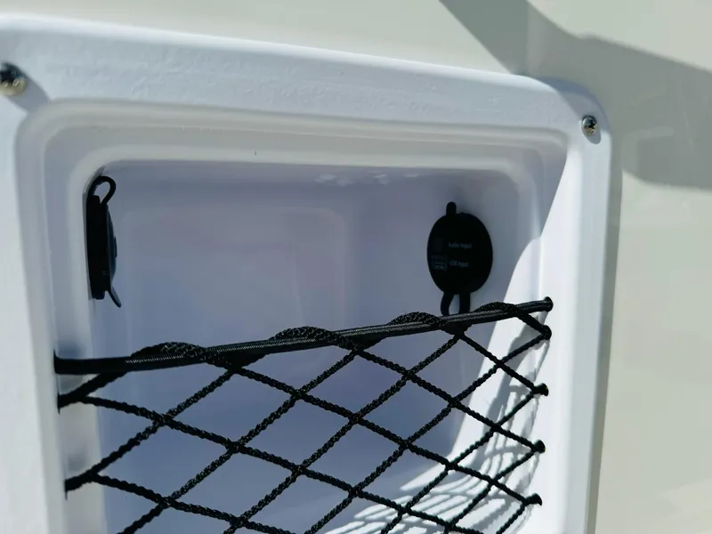 Slide: The Image of Storage compartment with netting on 2025 Bayliner Trophy T18 boat. - 21