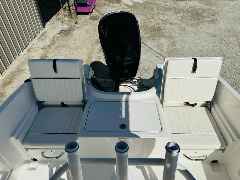 Slide: The Image of 2025 Bayliner Trophy T18 boat interior with seating and motor view. - 8