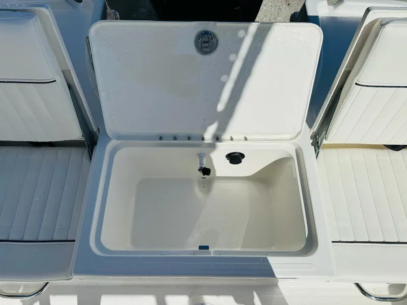 Slide: The Image of 2025 Bayliner Trophy T18 boat storage compartment with open lid, showcasing interior space. - 9